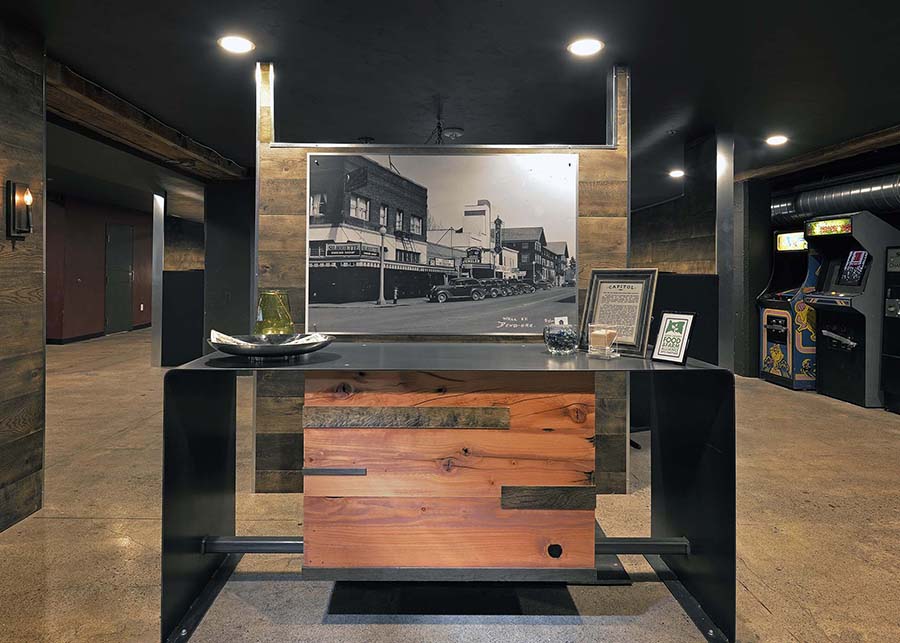 the hostess stand at the Capitol, custom-designed using deep rich woods against stainless steel accents, and featuring historic photos of downtown Bend
